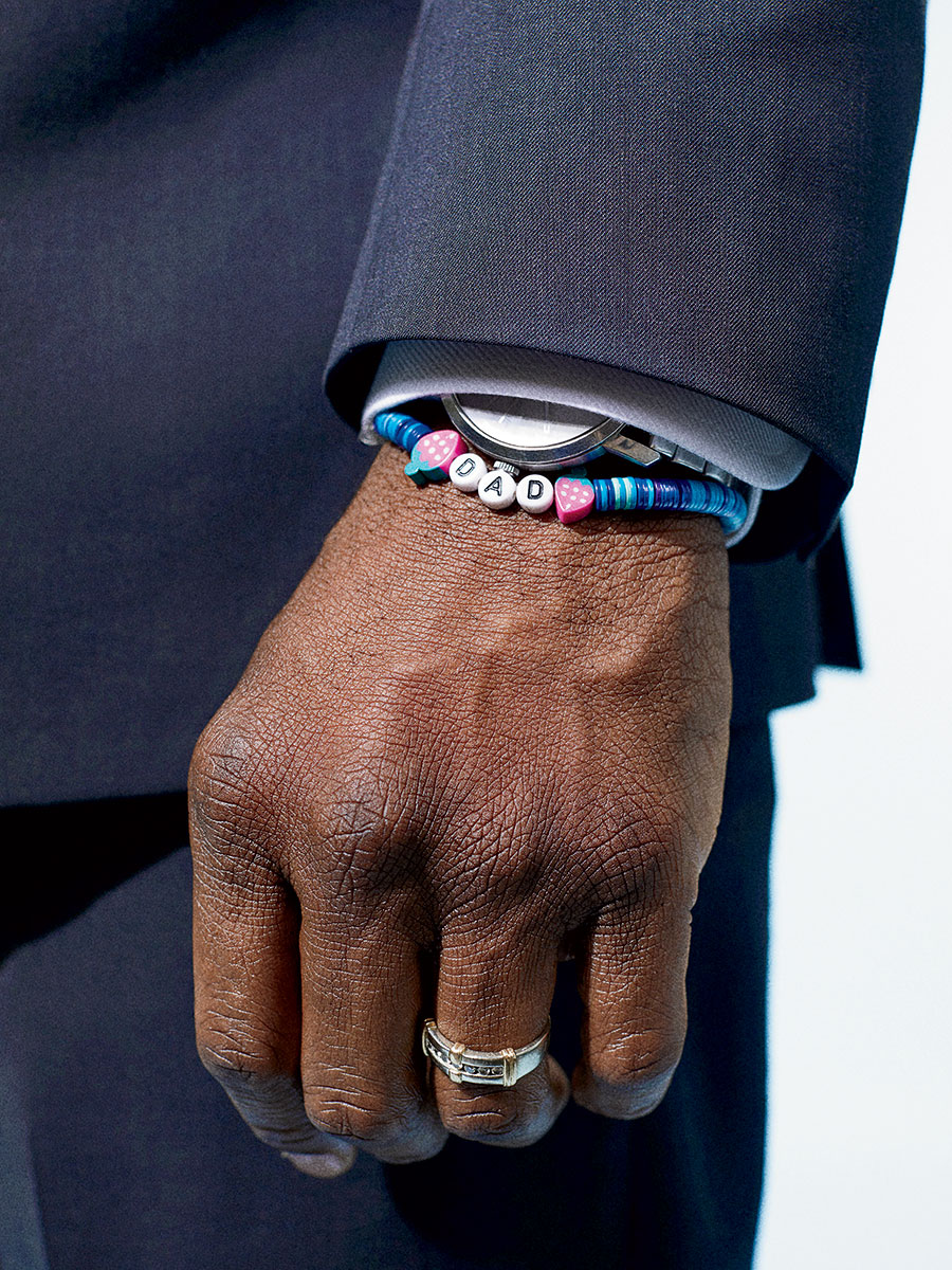 Brandon Johnson's wrist, adorned with a "Dad" bracelet