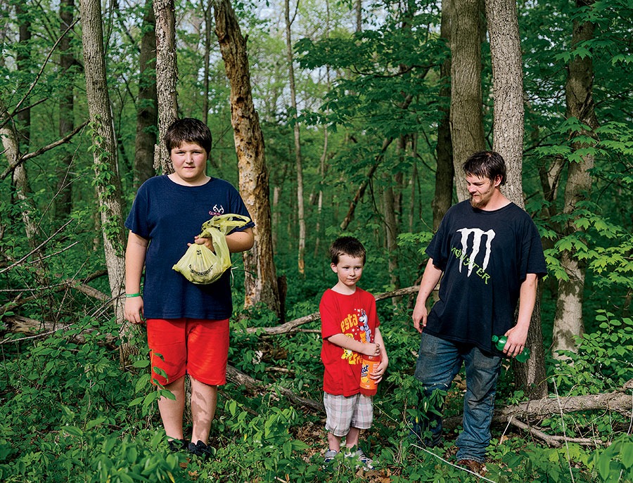 Jay Anderson and his sons Jayden (left) and Jay Jr. forage for morels at Mississippi Palisades State Park in Savanna.