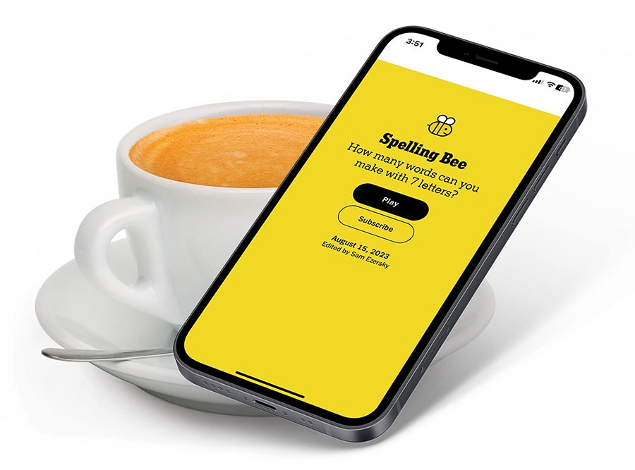 A cup of coffee and the New York Times' Spelling Bee displayed on a phone.