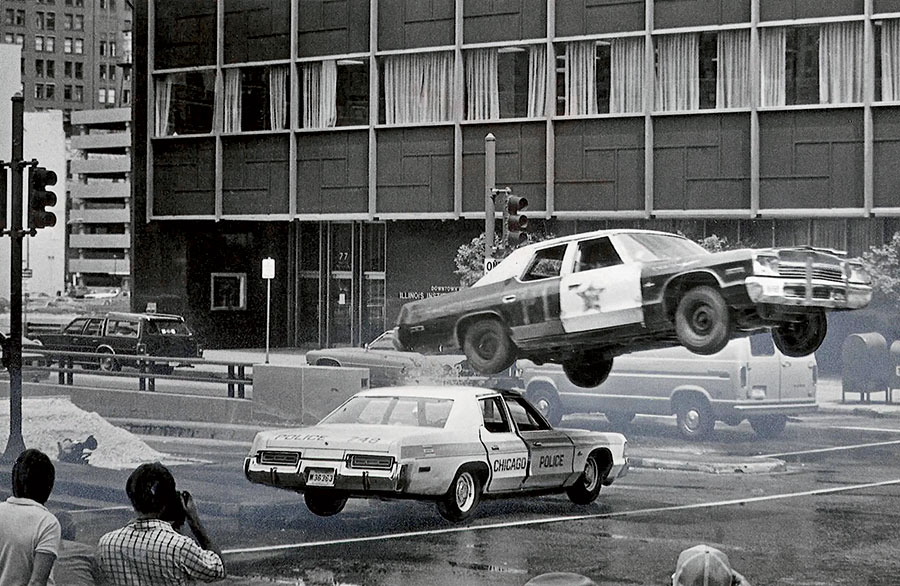 An airborne police car during a stunt