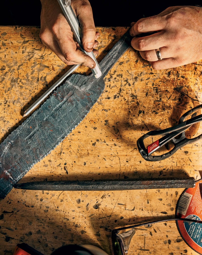 Goldbroch chalks a template for the nakiri knife onto the rough-shaped steel.