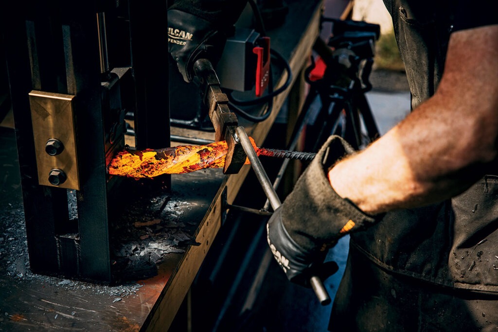 Goldbroch twists the steel to begin shaping it.
