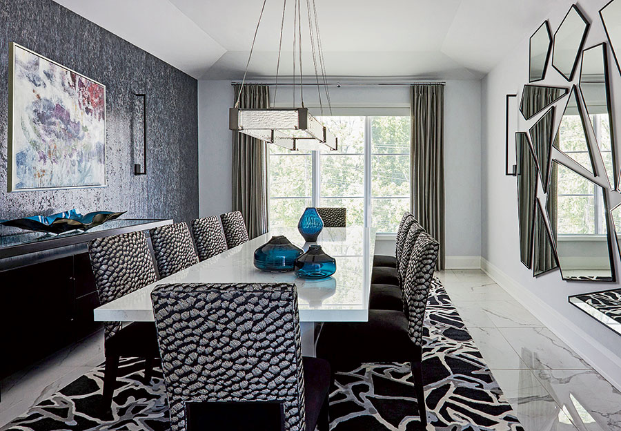 Contrasting patterns, from the Julie Dasher rug and Vahallan brushed wall panels to the upholstered Davos chairs from Charles Stewart, add interest in the dining room.