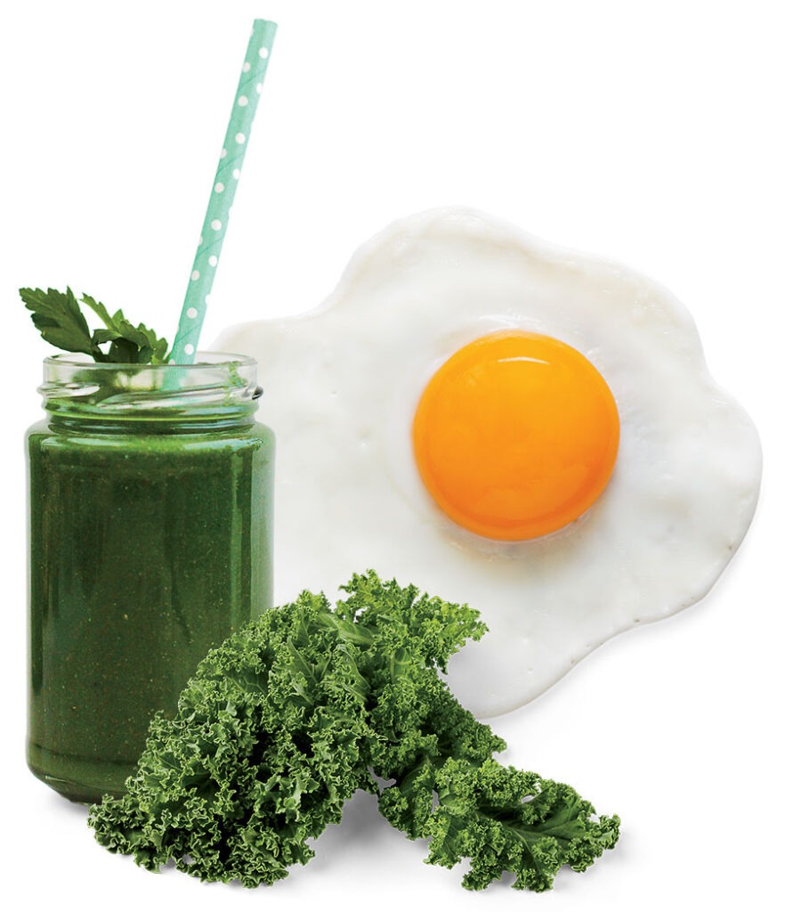 A green smoothie, a leaf of kale, and a fried egg