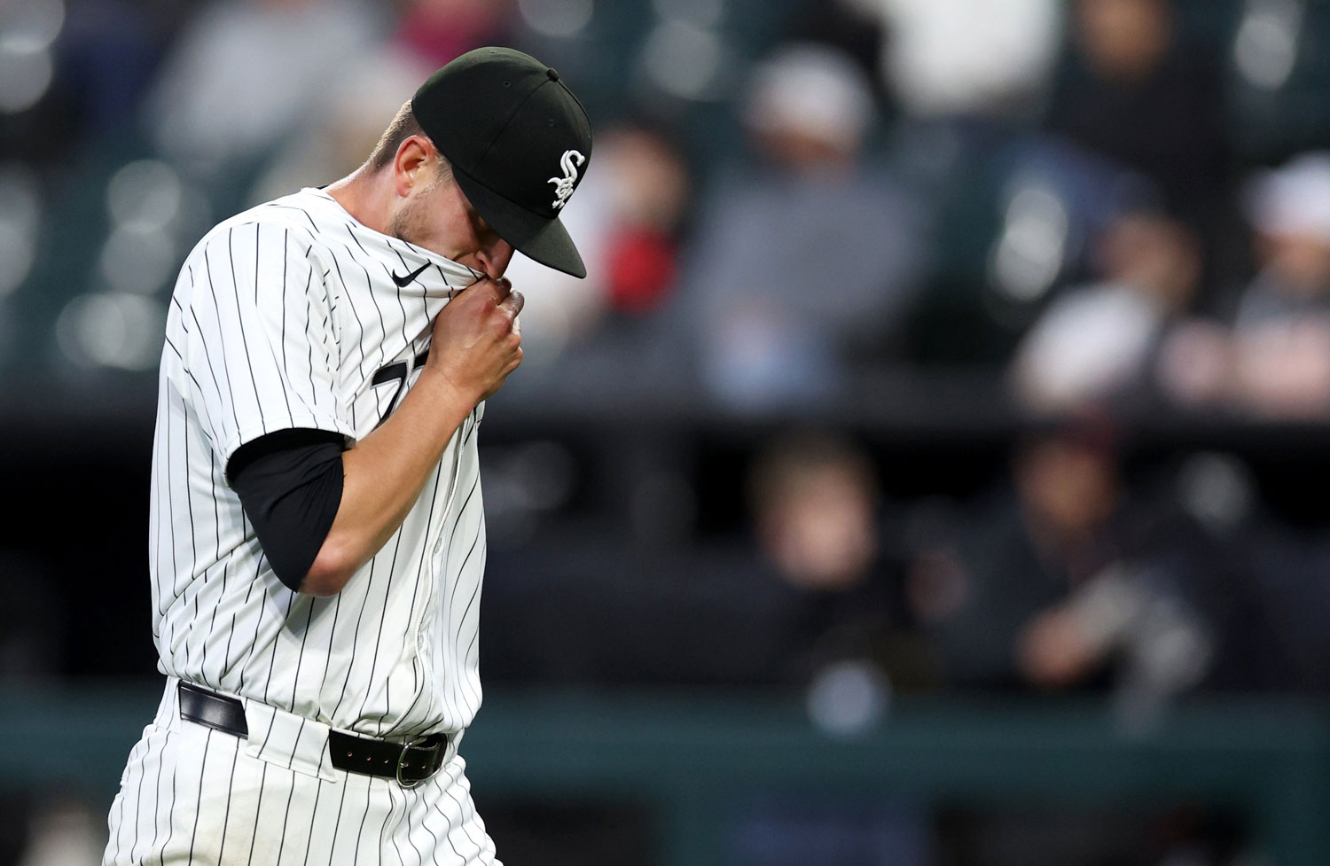 A Sox player wiping his face with his shirt