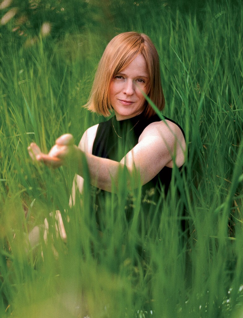Jessica Risker sitting in tall, green grass