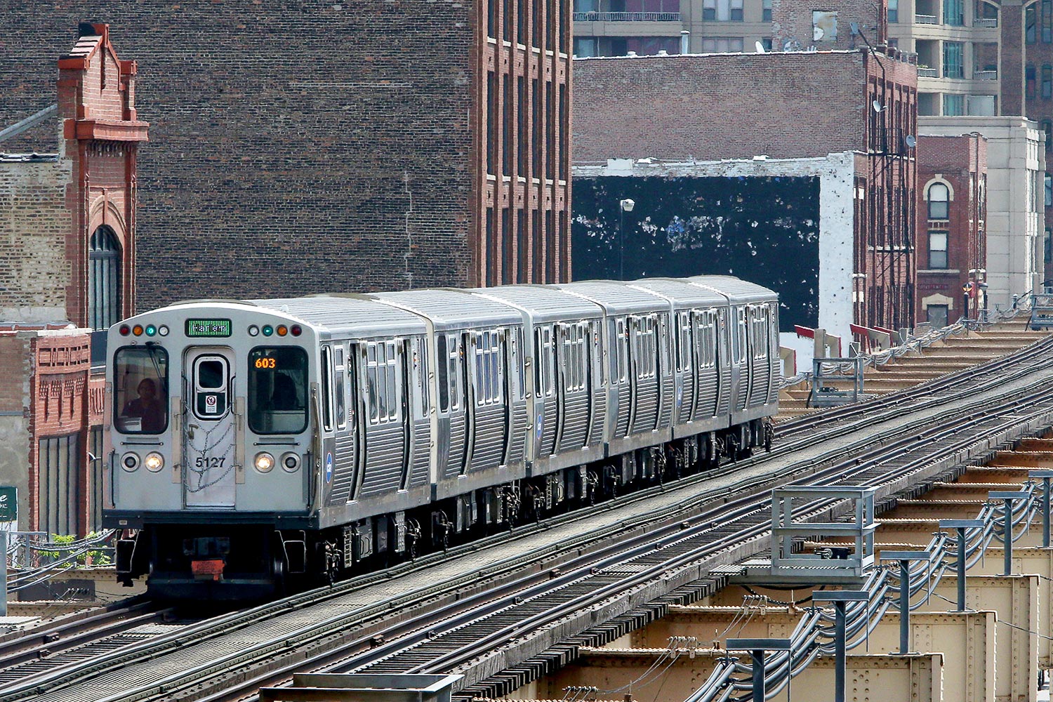 A Green Line train traveling on the elevated tracks