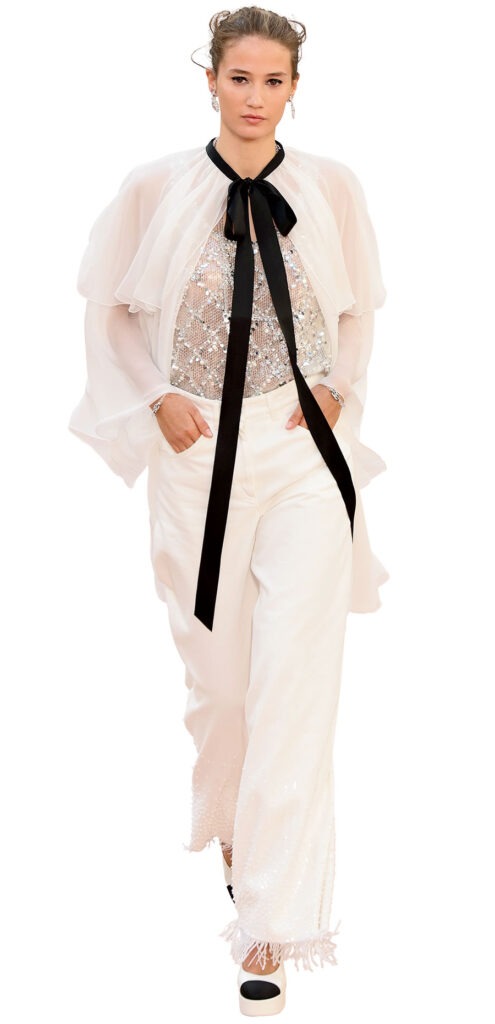Silk muslin cape, embroidered lace top, and bead-embellished denim jeans
