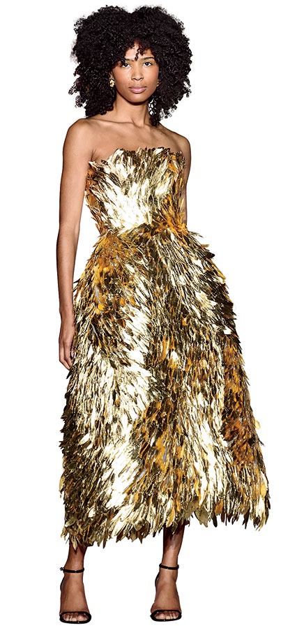 A model wearing a gold Oscar de la Renta dress