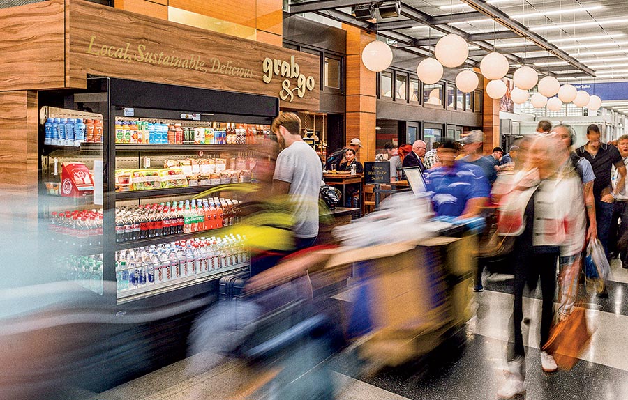 People shopping near the grab & go section at Publican Tavern at O'Hare Airport