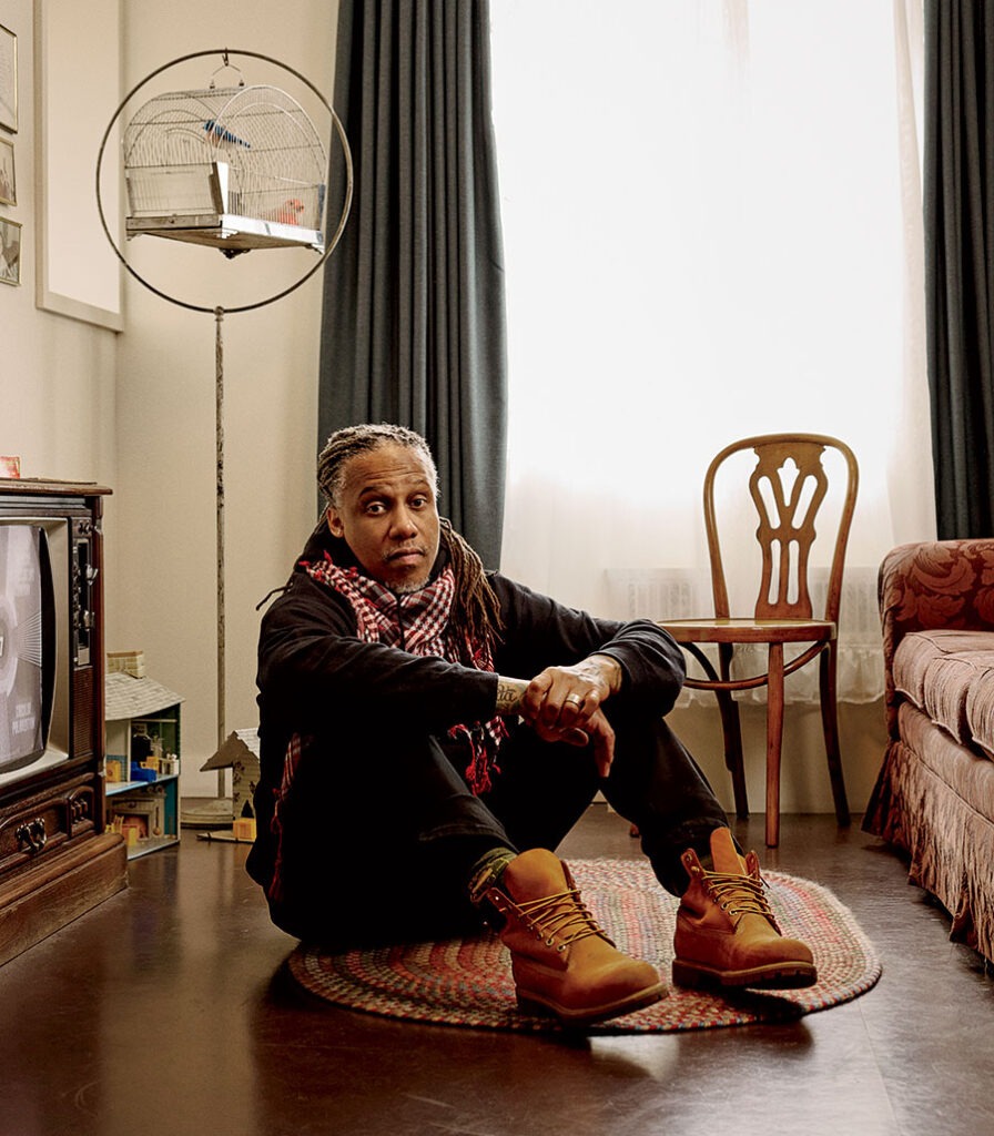 David Stovall seated on the floor of an old-fashioned living room