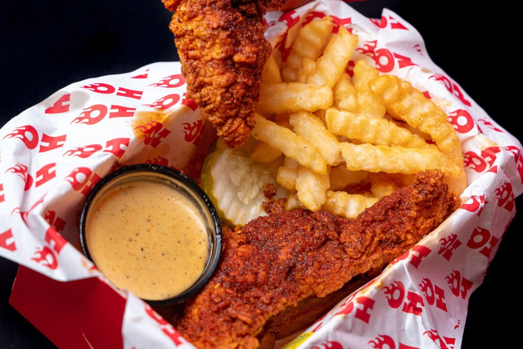 A basket of chicken, fries, and sauce at Hot Chi Chicken & Cones