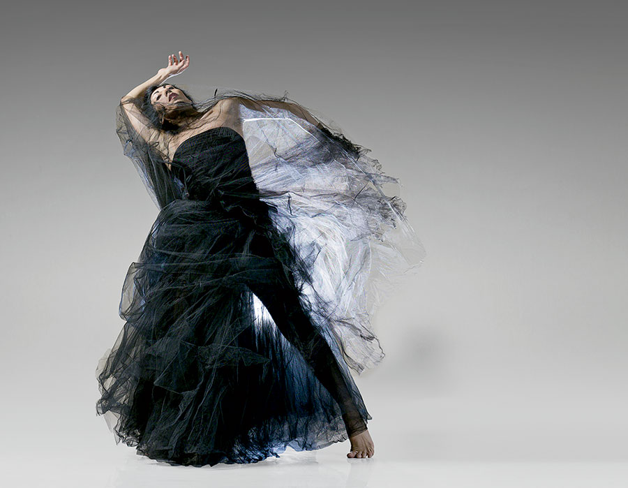 A dancer performing in a flowy black dress