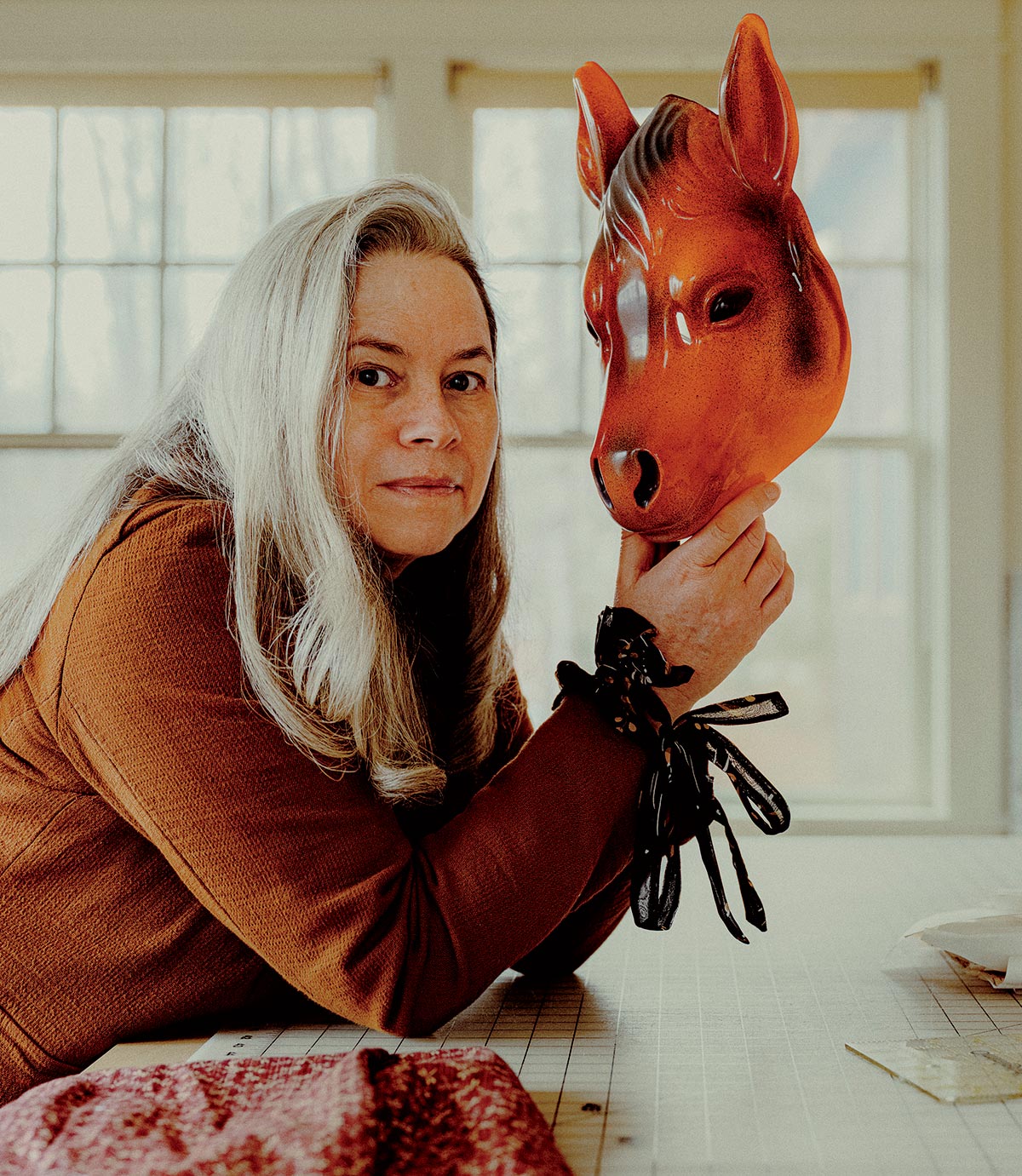 Natalie Merchant holding a horse mask