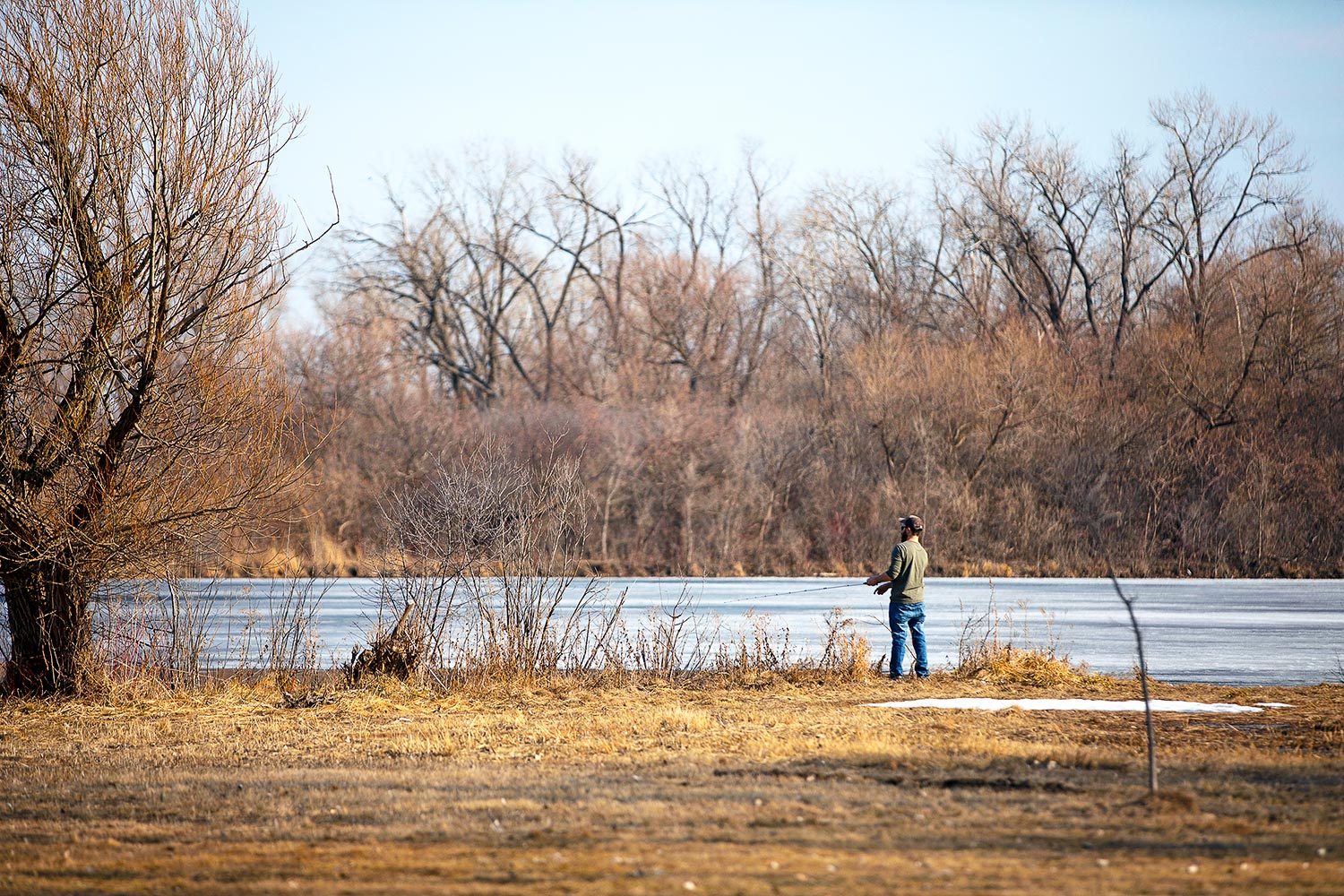 A person fishing in the William W. Powers State Recreation Area.